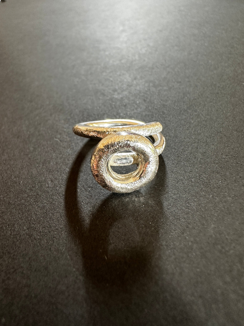 Silver circle ring on a dark gray background