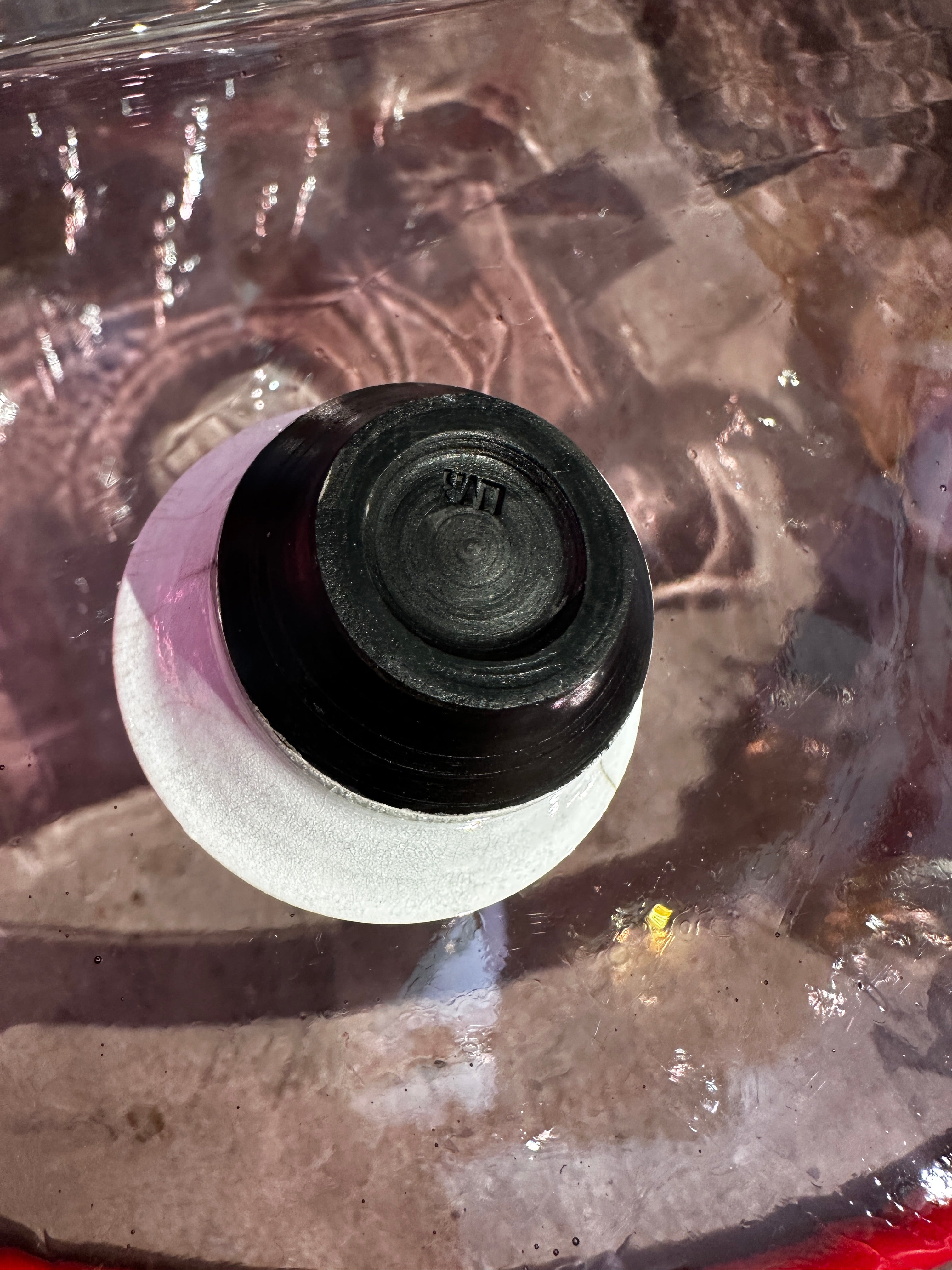 Close-up of bottom of a black and white bowl on a reflective surface